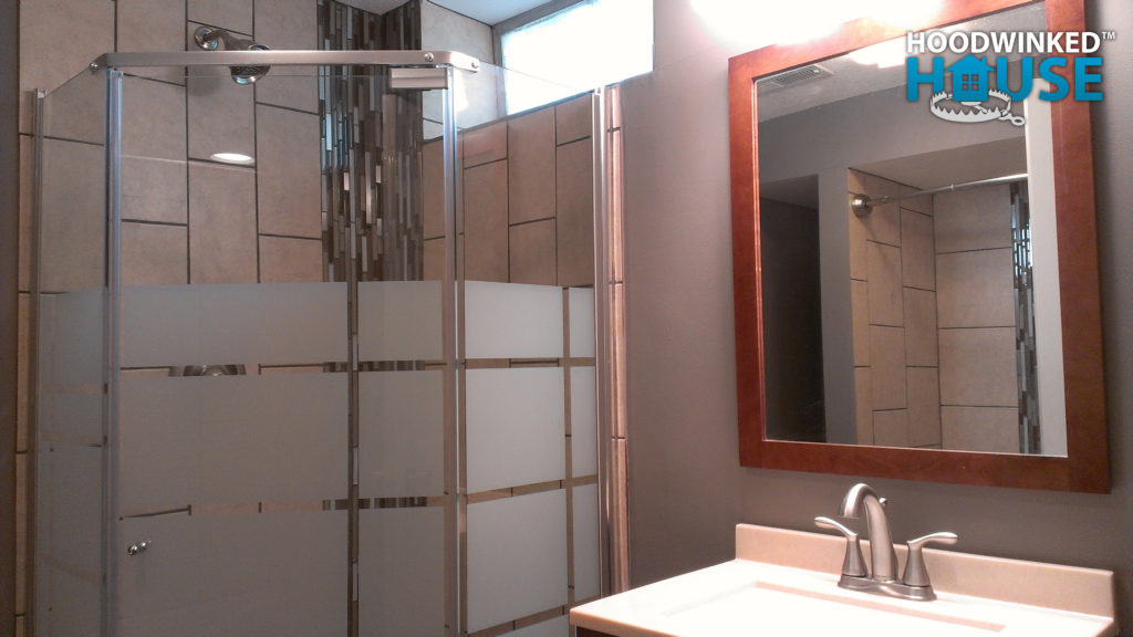 Remodeled basement bathroom with corner shower