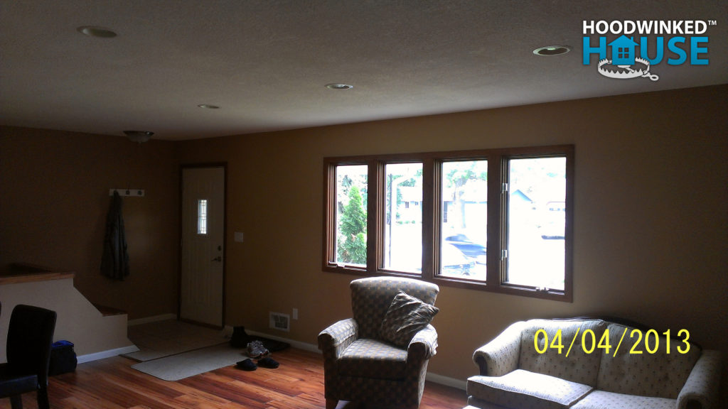 Living room with windows, and door, but closet removed.