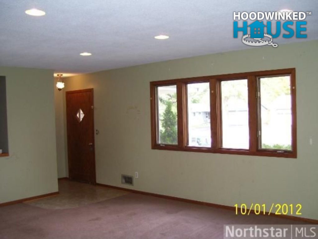 Living room with windows, door, and closet.