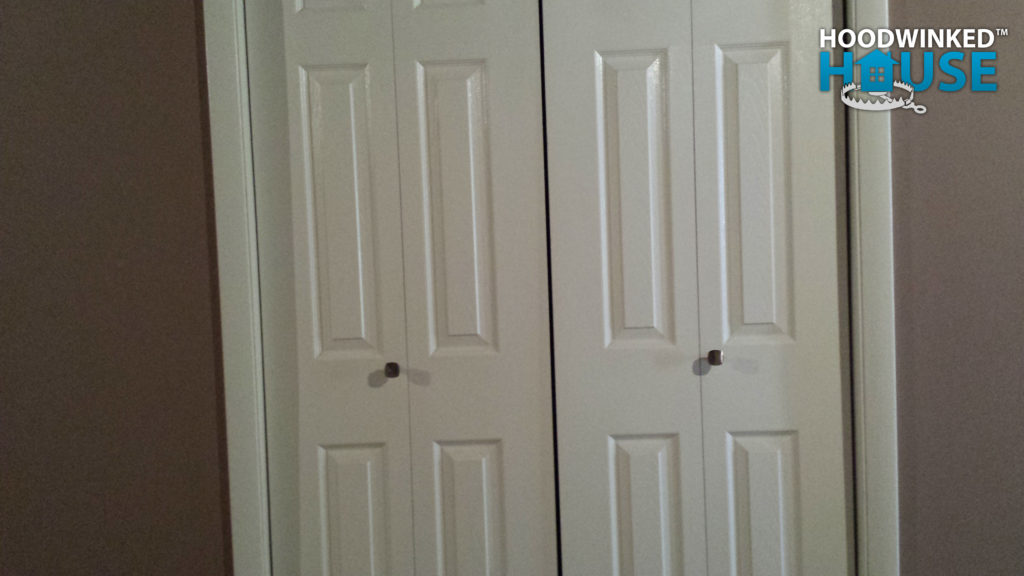 Bifold closet doors with handles installed on the wrong half of each door