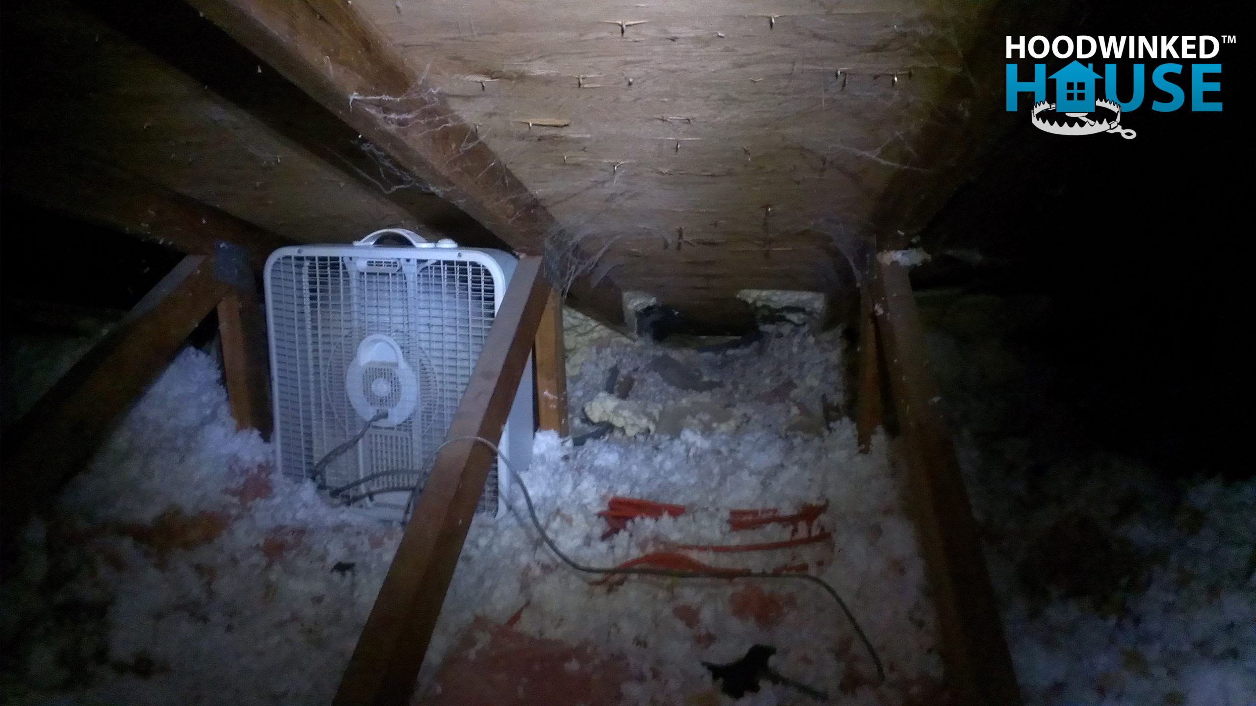 A box fan in an attic keeps ice dams frozen until the damage can be repaired in warmer weather.