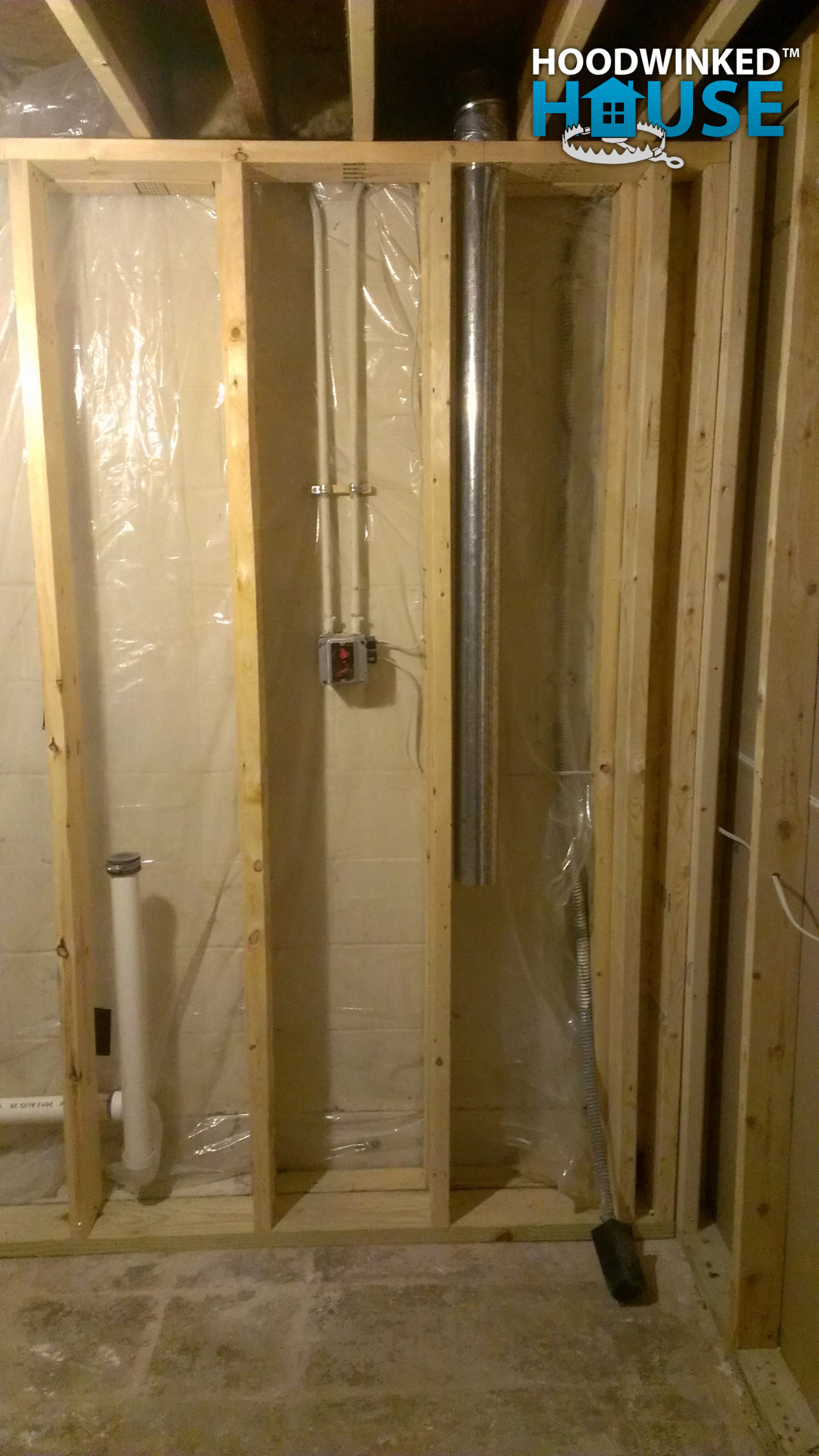 Framing in a basement over drain pies and a dryer vent.