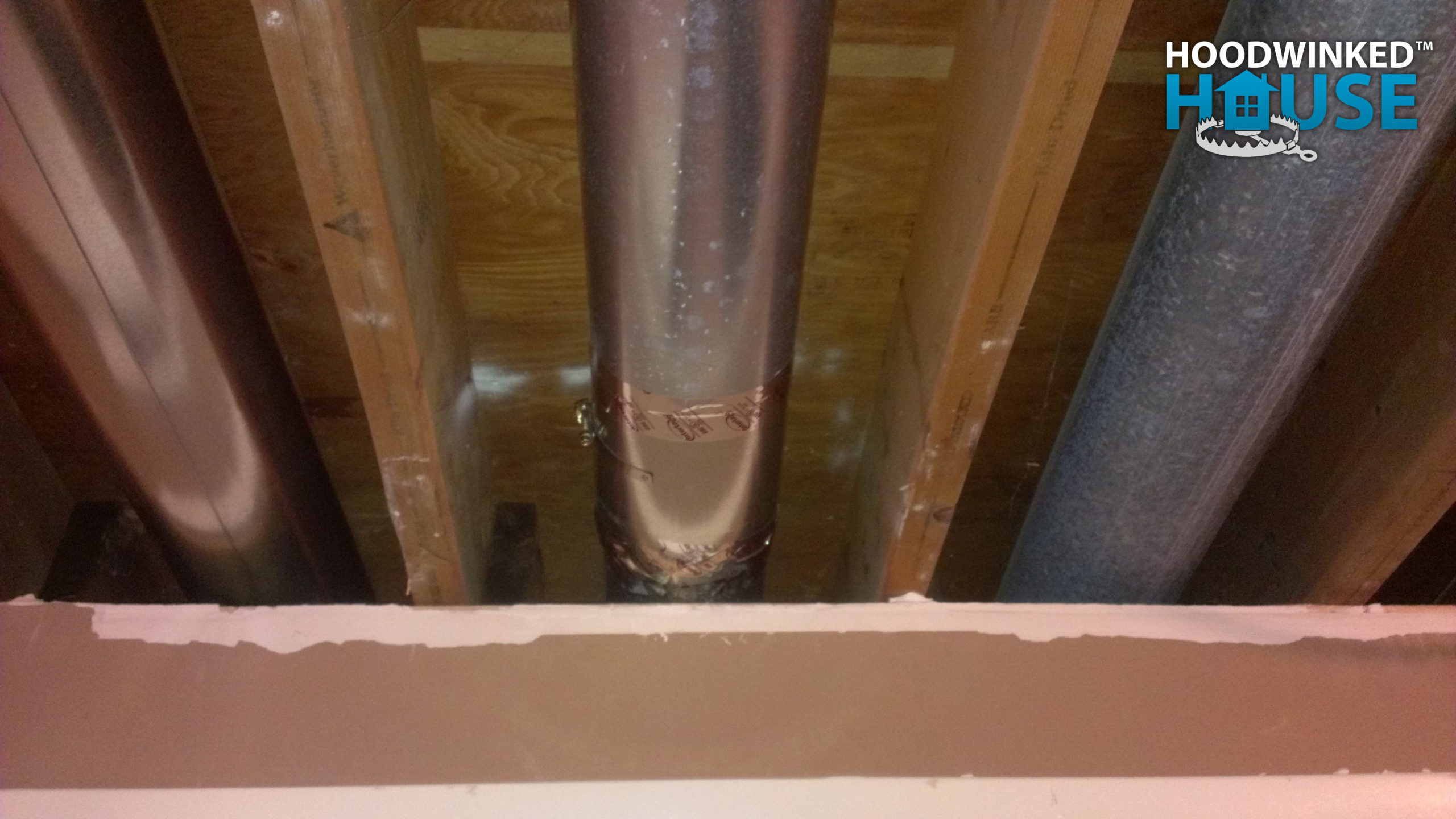 A basement air duct has been repaired with a patch.