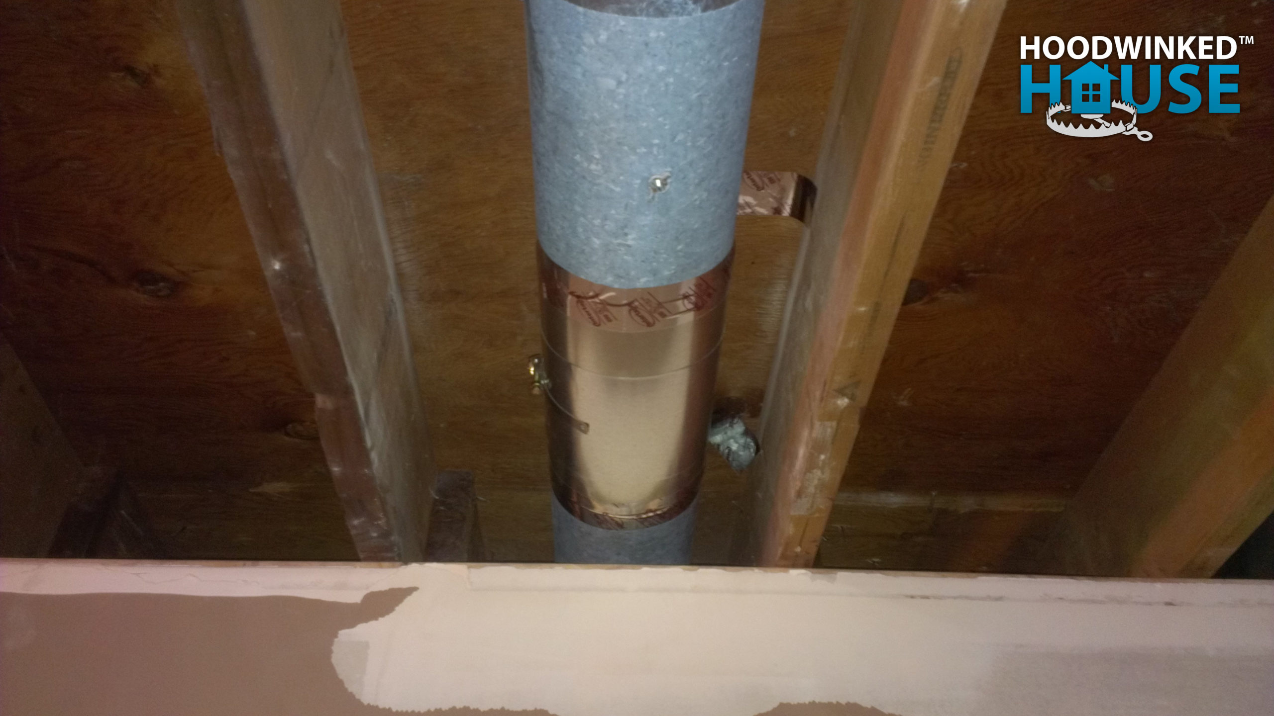A basement air duct has been repaired with a patch.