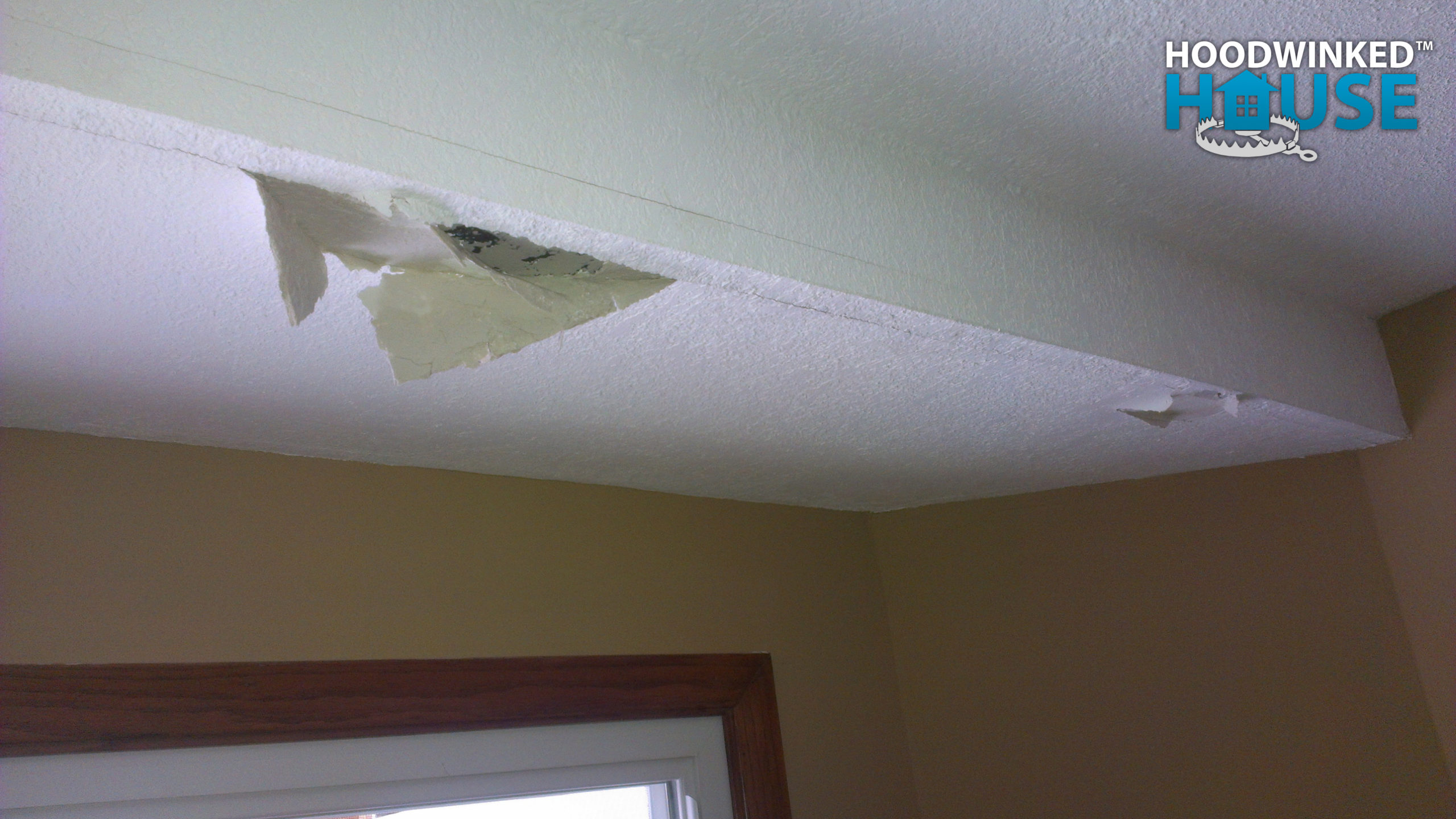 Ice dams on the roof push their way inside the house, causing damage to the ceiling drywall in this eve soffit.