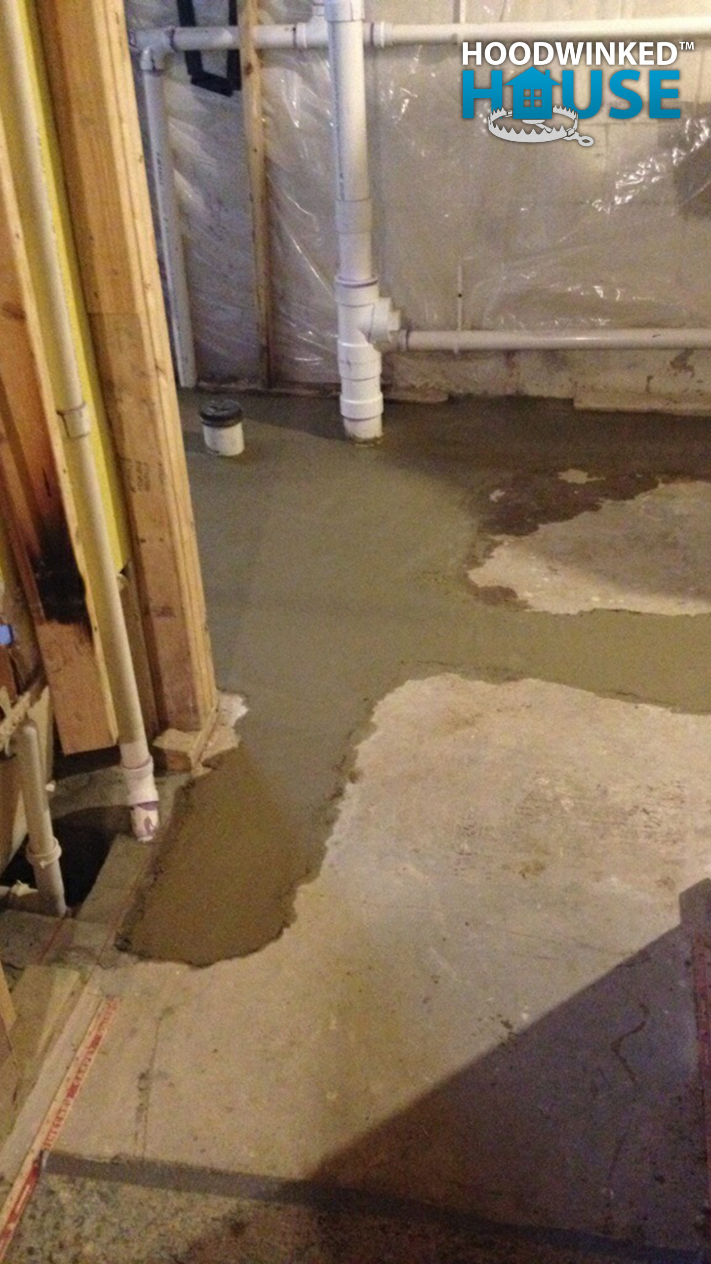 New concrete dries in a patched basement floor.