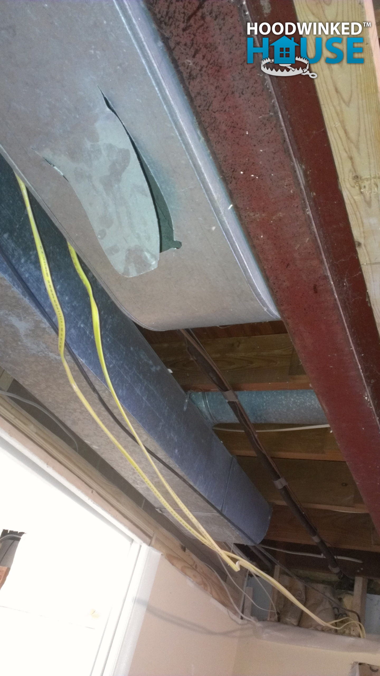 The main duct in a house with a large flap hole cut in it.
