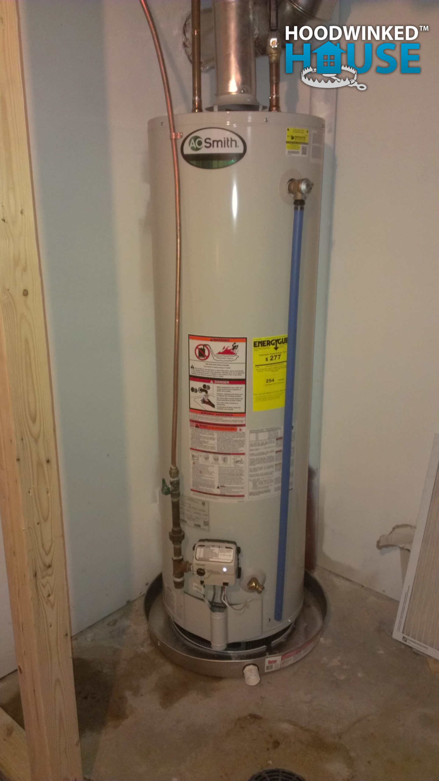 AO Smith water heater installed in a basement with a drip pan.