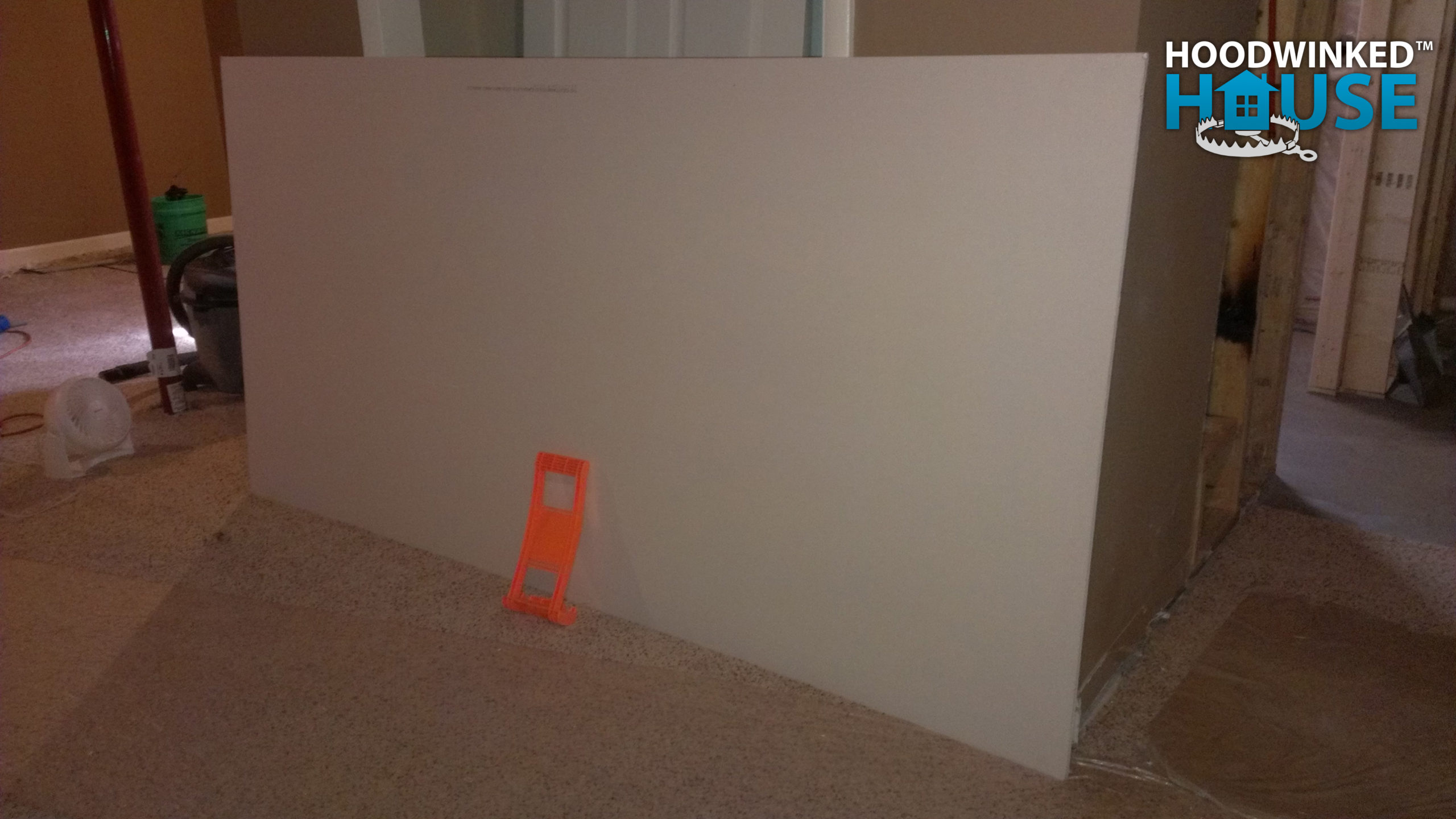 A couple sheets of drywall were purchased and carried into the basement with a carrying handle to see if they would turn a tight corner at the bottom of the staircase.