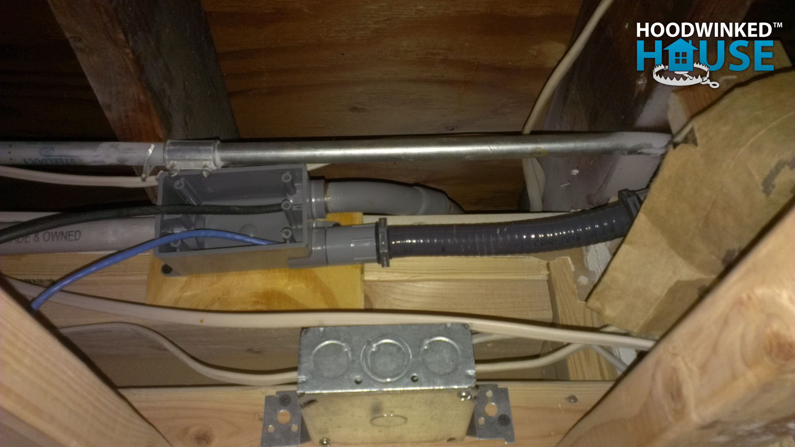 A network conduit in a basement ceiling holds CAT6 and CATV coax cables.