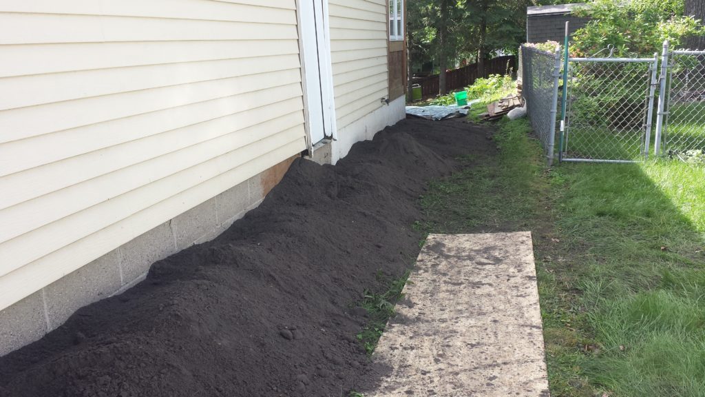 Dirt used to correct the grade in a side yard.