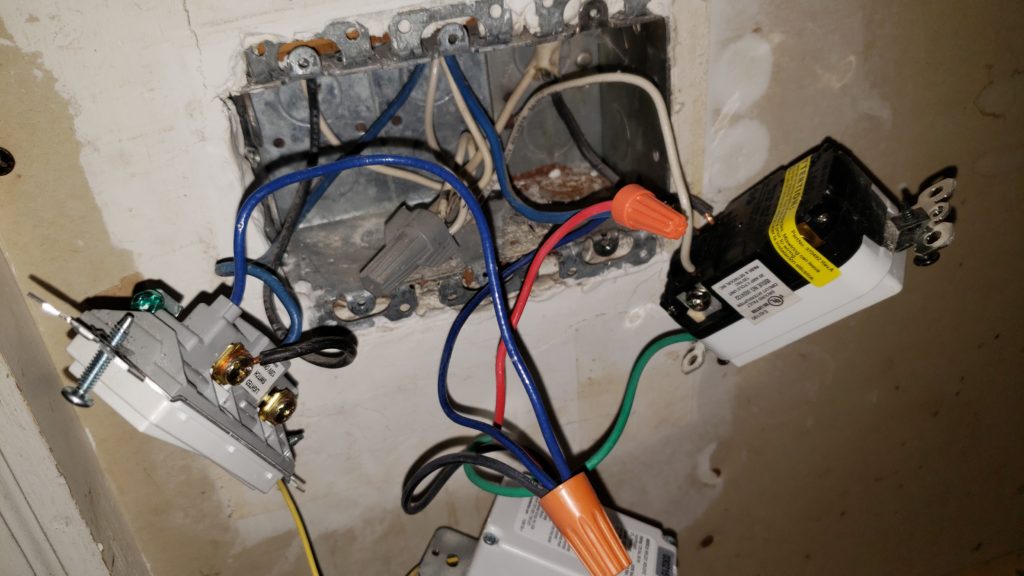 A junction box with many light switches removed.