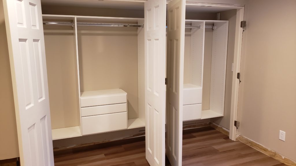 Closet systems installed in a pair of side-by-side closets.