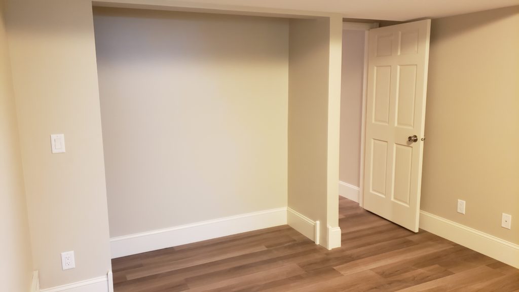 A bare closet shown without doors or shelving.