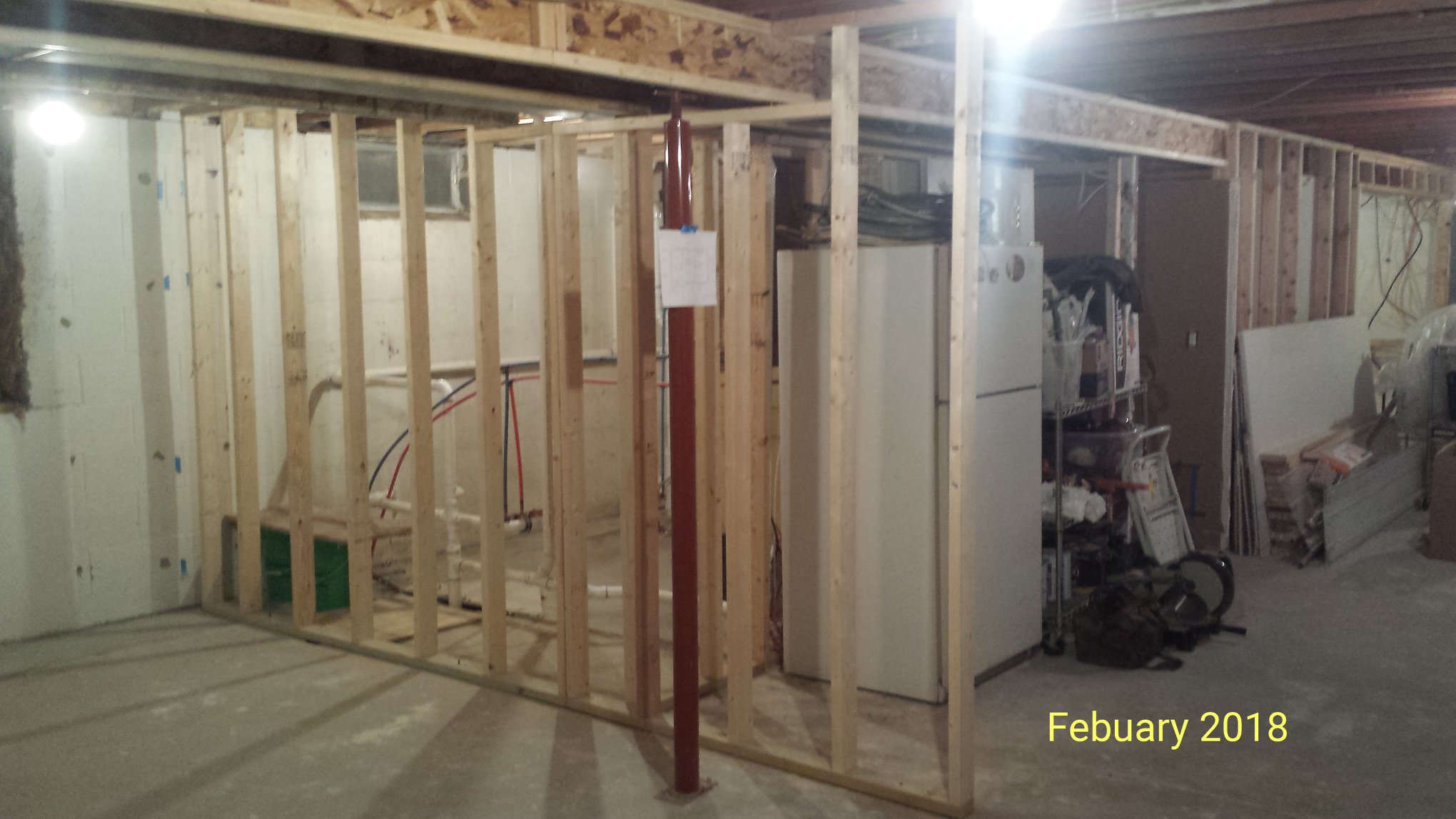 A stud wall is installed in an unfinished basement as seen in February 2018.