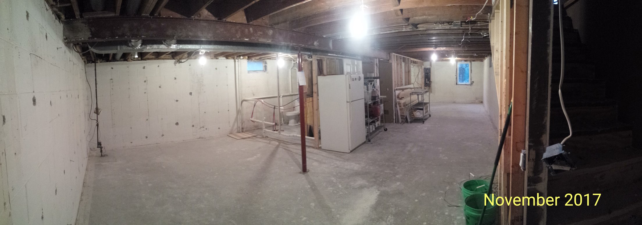 An empty basement with bare walls prepared for drain tile installation.