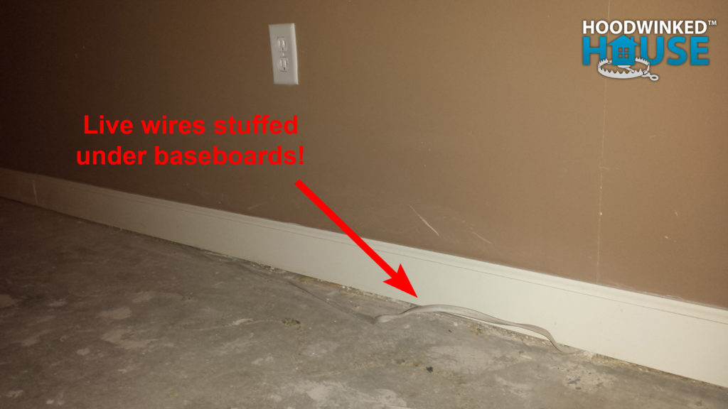 Live wires stuffed under baseboards.