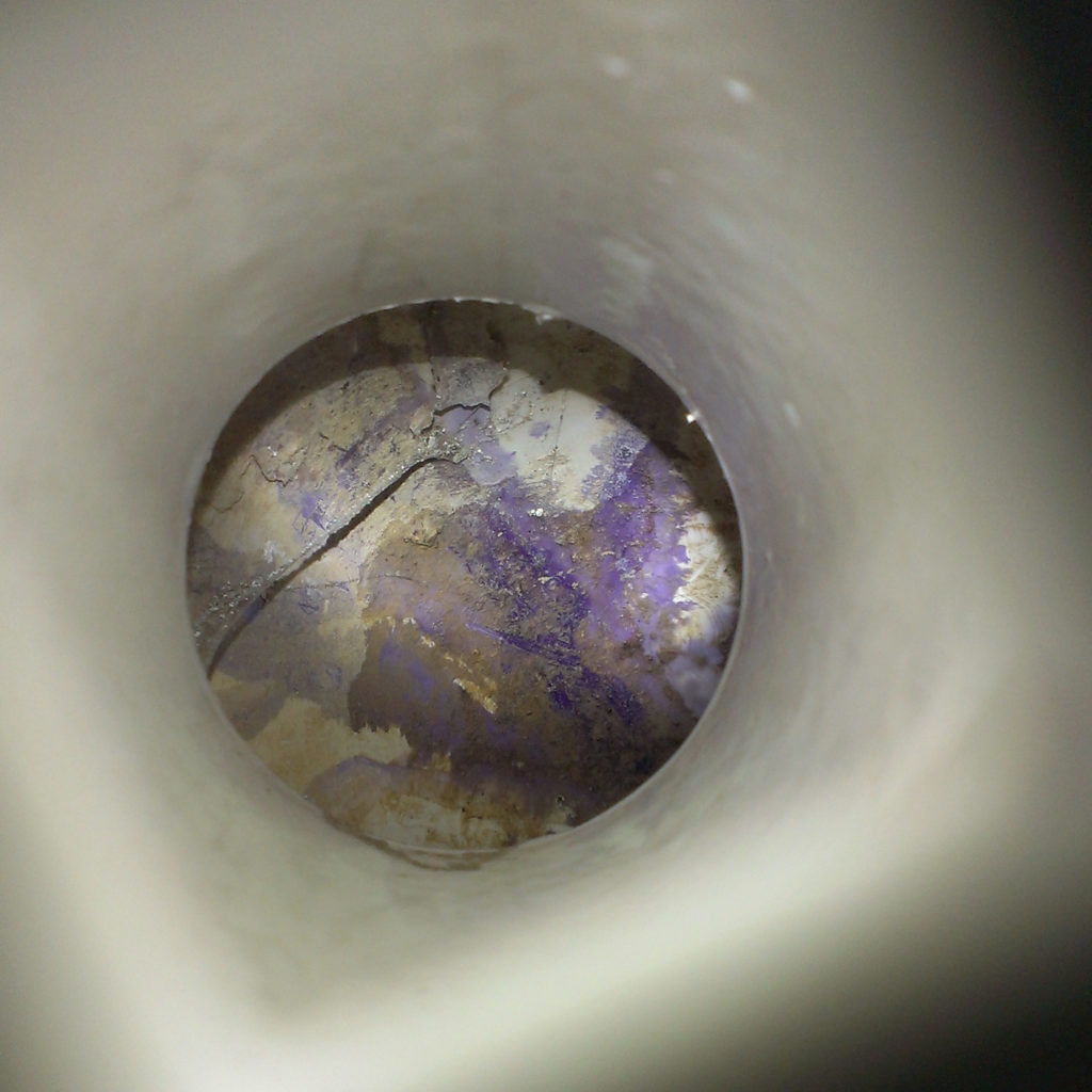 View inside a shower drain, revealing no P-trap.