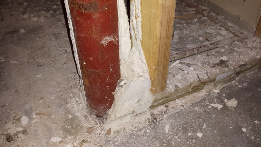 Drywall mud improperly used on a basement support column.