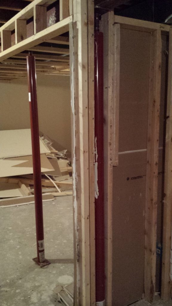 Lumber framing around a basement support column.