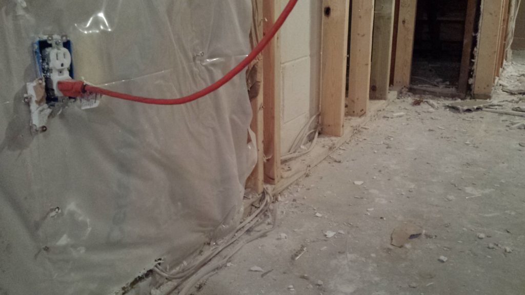 Basement demolition reveals wires that were run behind framing and baseboards.