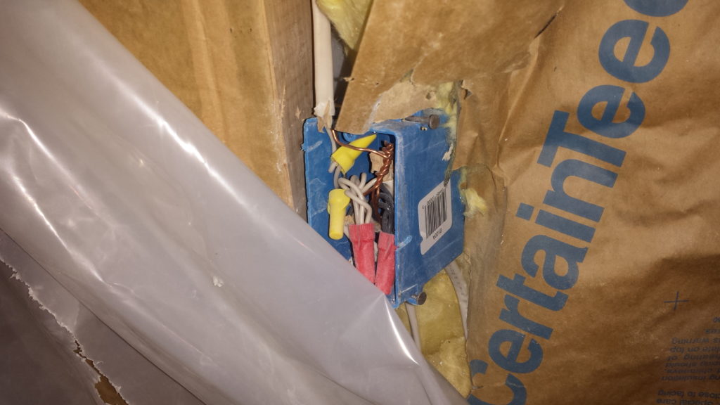 Demolition reveals a junction box that was hidden behind drywall.