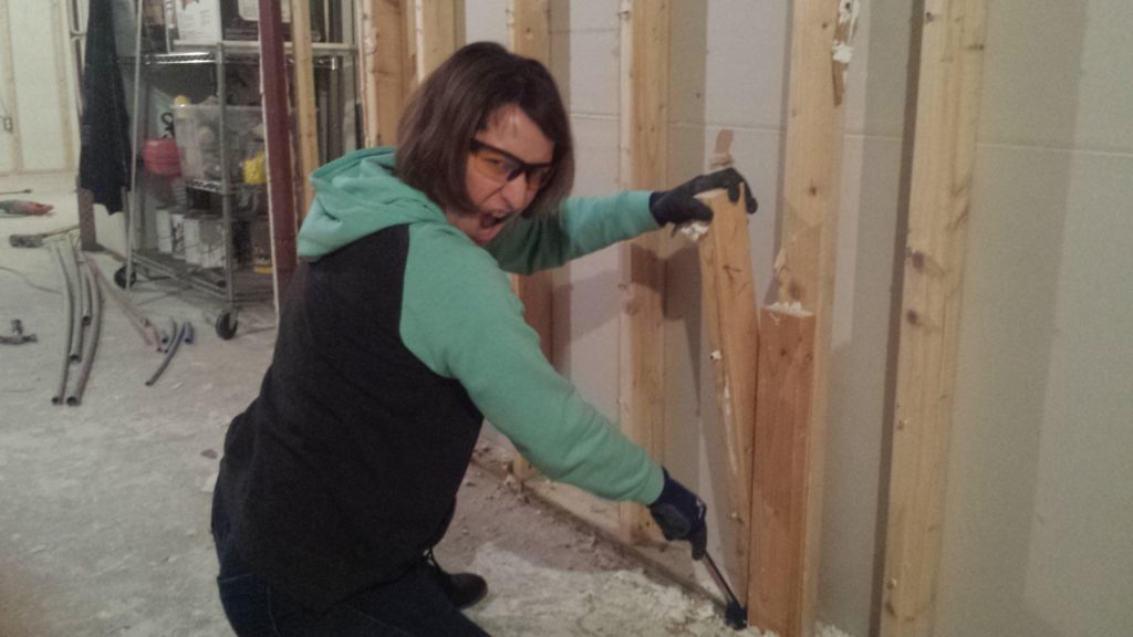 Demolishing flawed framing in a basement.