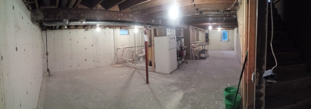 Basement with all framing removed, ready for a drain tile project.