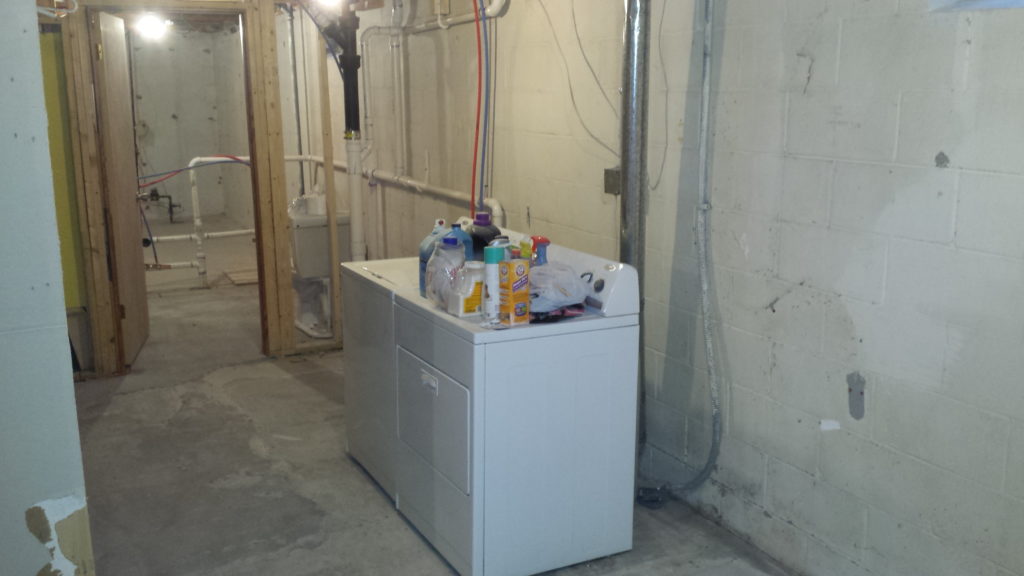 Basement laundry room with all finished framing demolished.