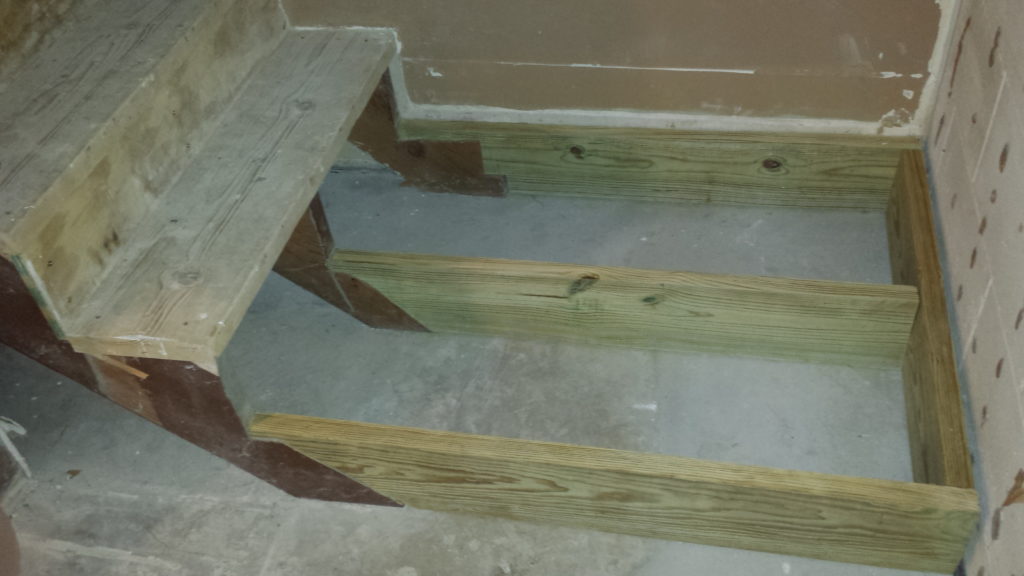 Framing for a basement stair landing.