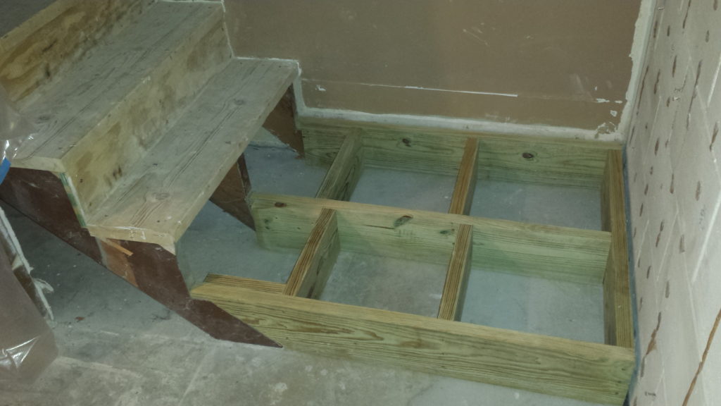 Framing for a basement stair landing.