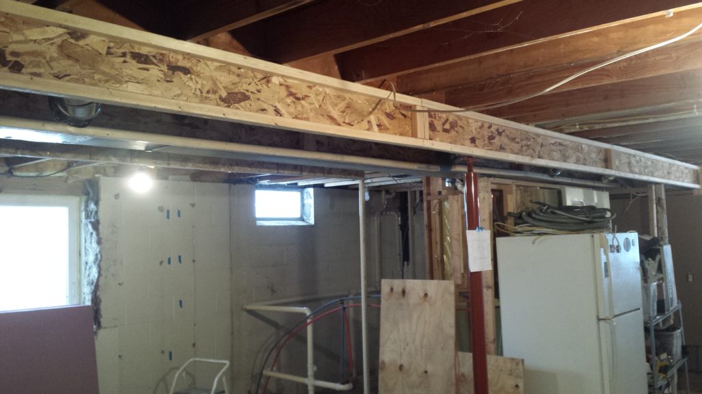Soffit framing around a beam in a basement using 3/8" OSB and 2x2s.