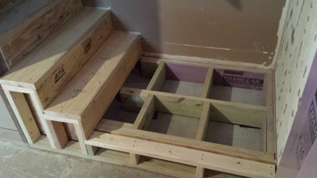 Rough in framing for a basement stair landing.