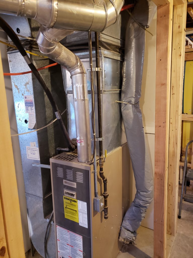 A furnace flexible fresh air intake is shown kinked in a few places.