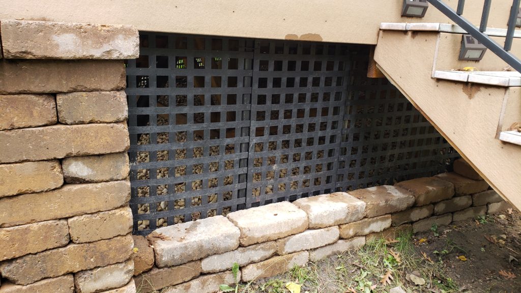 Lattice skirting around a deck. There is an access door here.