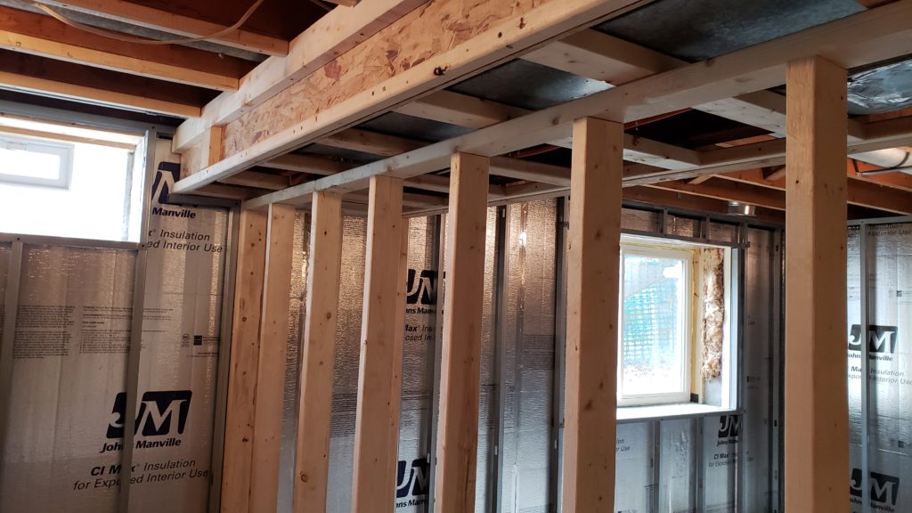 Stud wall framing in a basement.