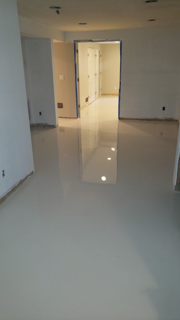 Self-leveling concrete that has been poured over an entire basement floor.