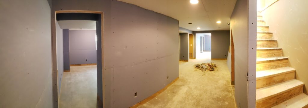 A basement with purple mold resistant drywall.