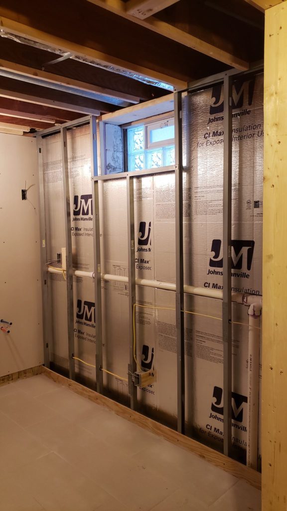 Metal stud wall framing in a basement bathroom.