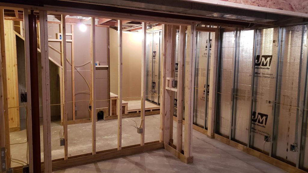 Stud wall framing for a closet in a basement bedroom.