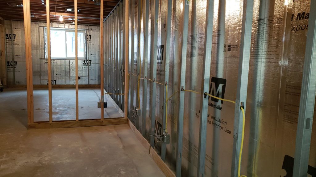 Basement with metal studs and electrical rough-in complete.