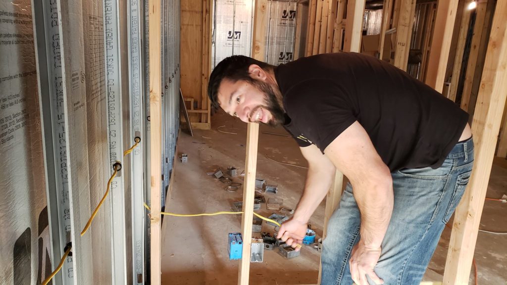 Electrical rough-in of a basement with metal studs.