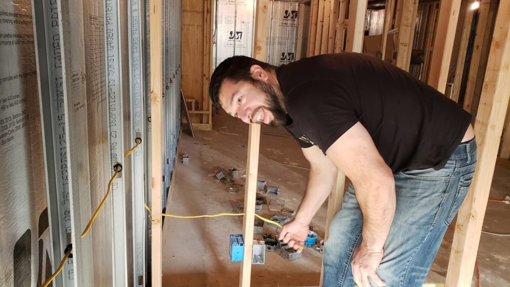 Electrical rough-in of a basement with metal studs.