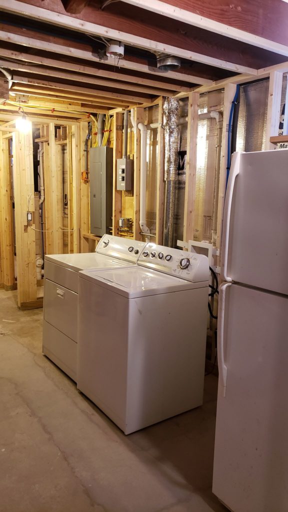 Laundry room in an unfinished basement.